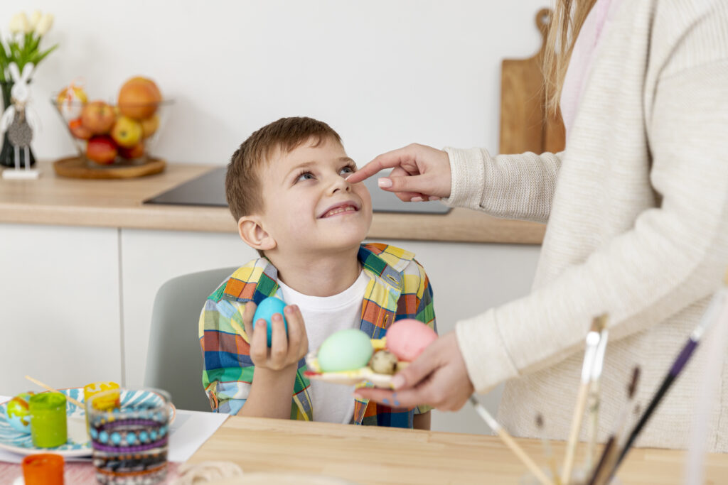 high angle mom with son making eggs easter