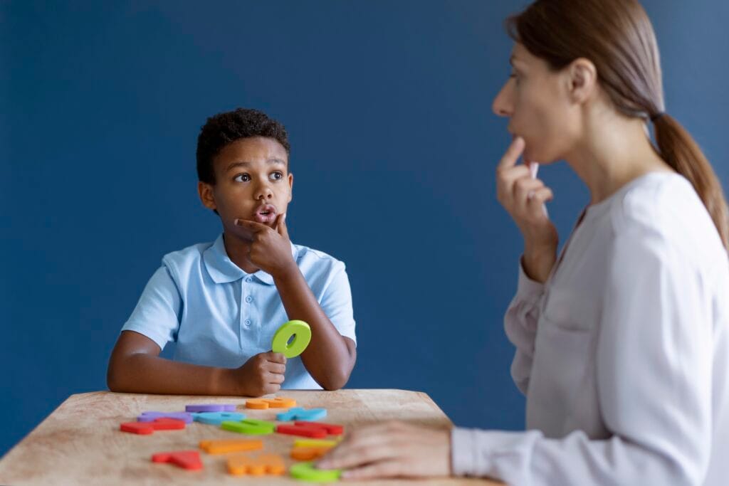 boy having occupational therapy session with psychologist