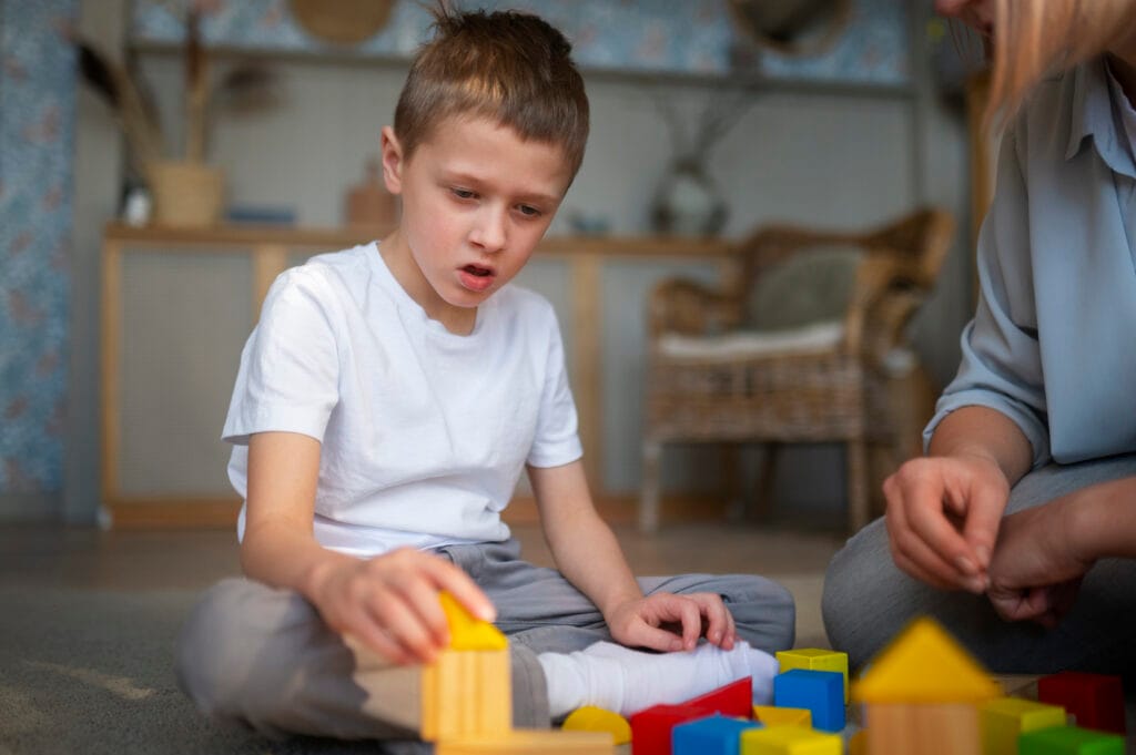 mother playing with her autistic son using toys