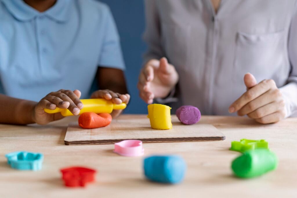 kid doing occupational therapy session with psychologist