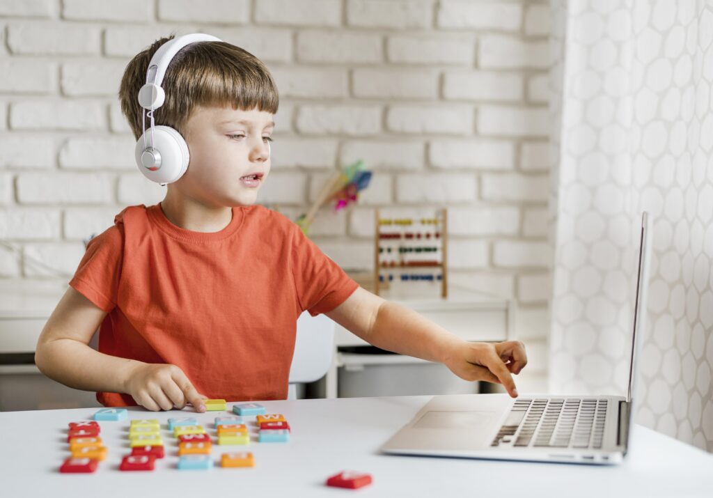 medium shot boy with laptop 1